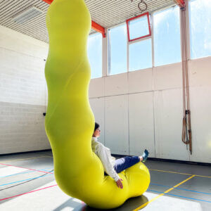 The LARVA is made from a massive sleeve of aerial silk fabric and filled with yoga balls to create a caterpillar-like structure.